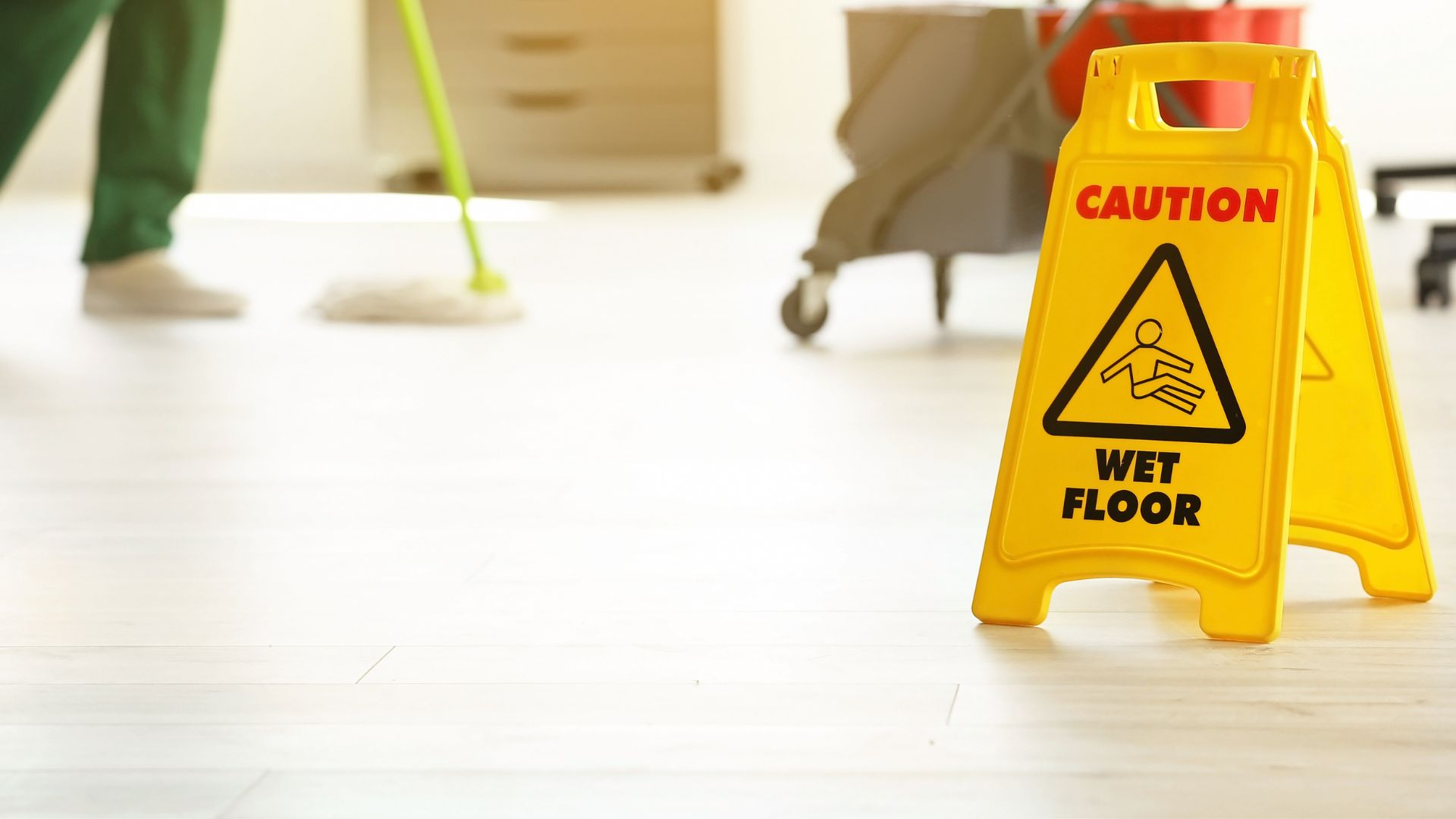 wet floor from mopping with a caution sign